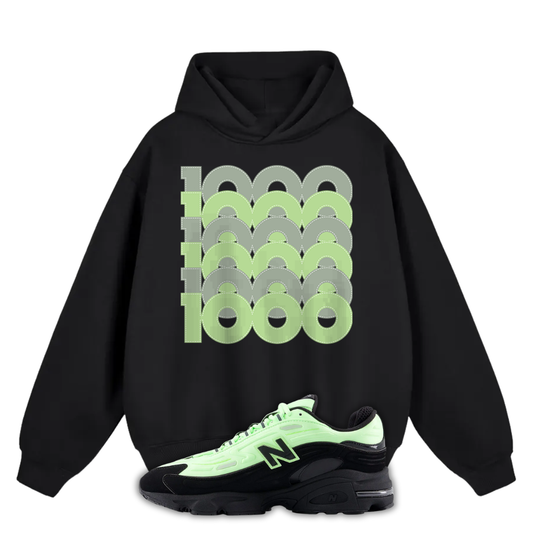 Black hoodie with green and gray pattern and a New Balance 1000 Black Neon Green sneaker on a white background