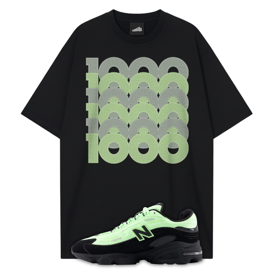 Black t-shirt with green and gray graphic design and a matching New Balance 1000 Black Neon Green sneakers on a white background