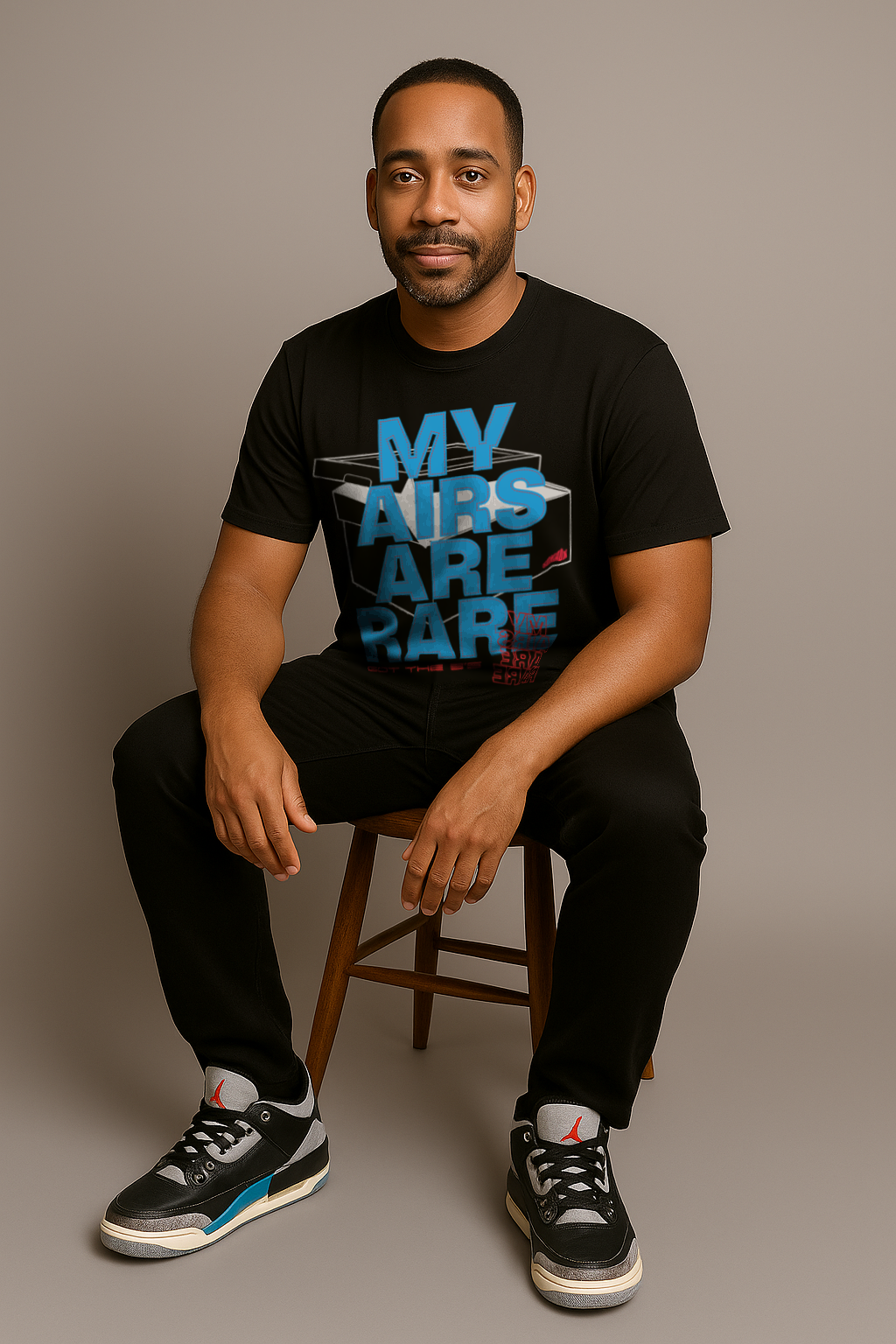 Man sitting wearing black tee designed to match Air Jordan 3 Rare Air with "My Airs are Rare" on the front.