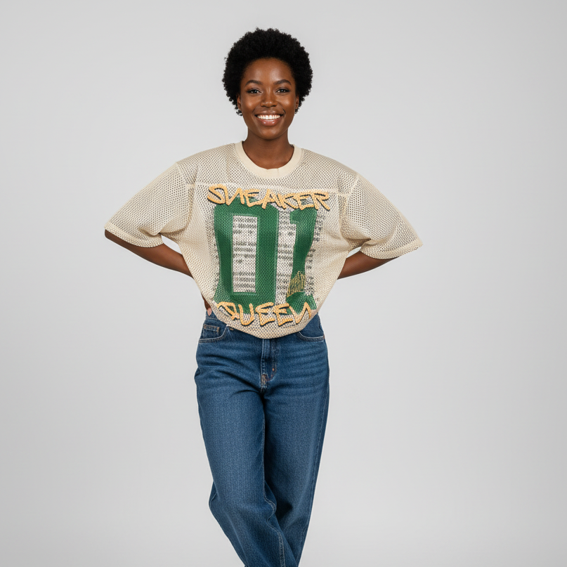 Woman wearing a vintage-style t-shirt with graphic design and blue jeans on a plain background