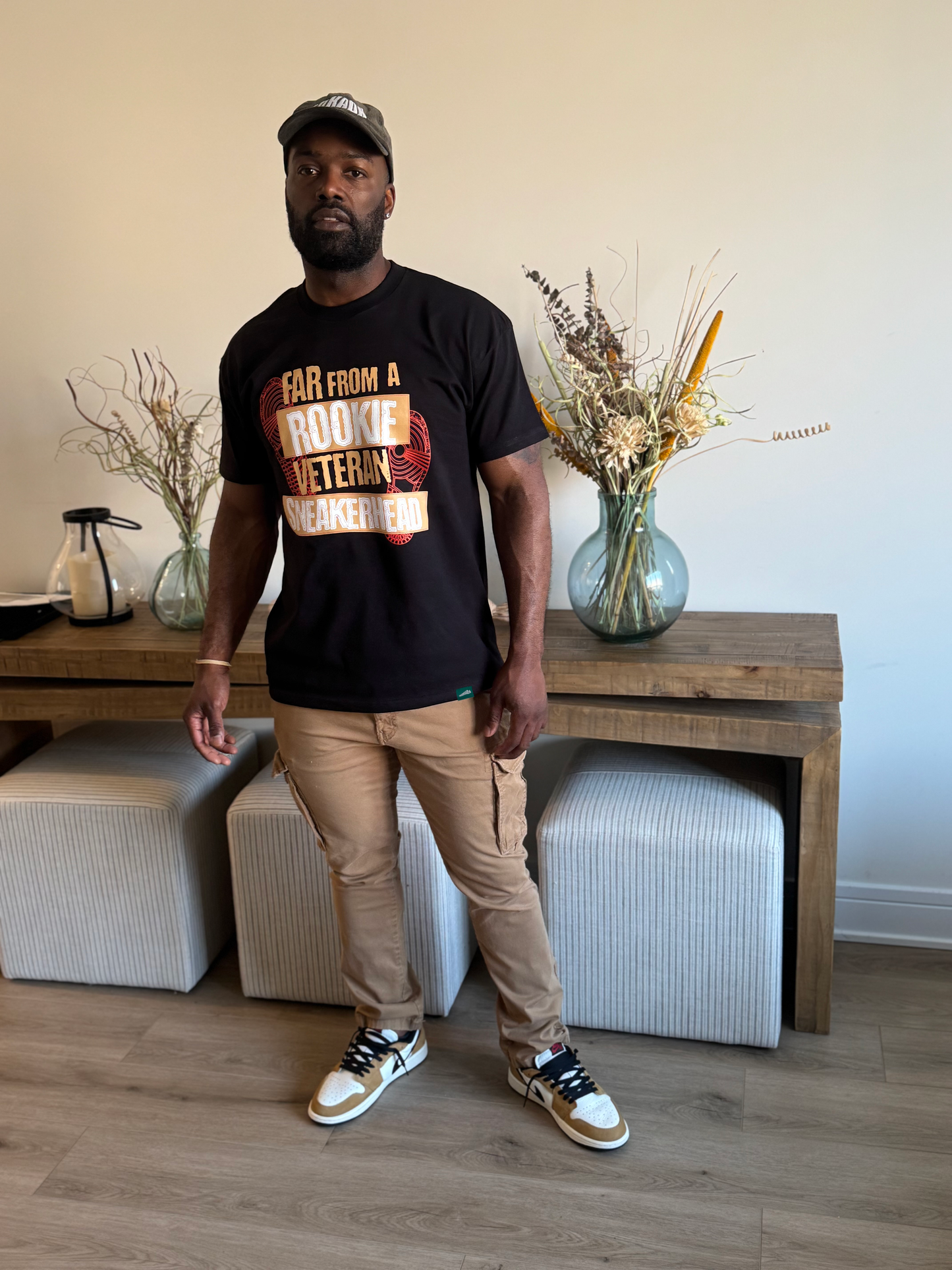 man standing wearing black tee to match air jordan 1 rookie of the year low