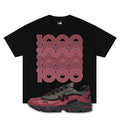 Black t-shirt with red geometric design and a red and black New Balance 1000 Monarch Burgundy sneaker below on a white background