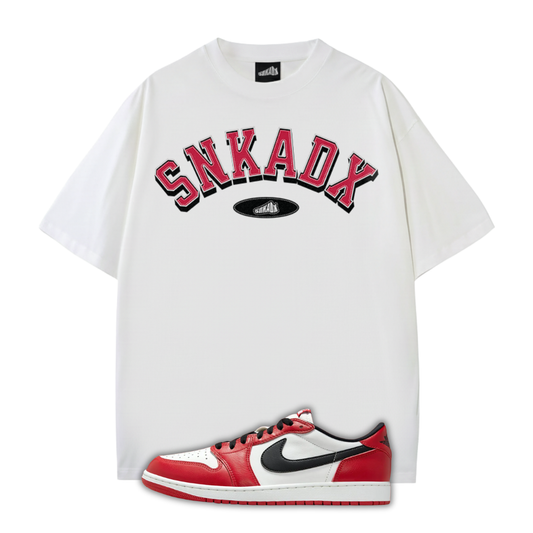 White t-shirt with 'SNKADX' text and a Jordan 1 Chicago sneaker on a white background