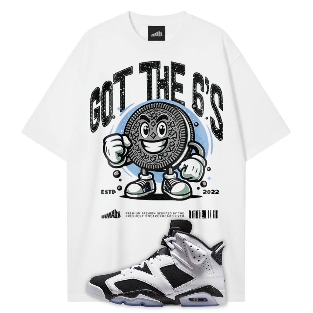 A white graphic T-shirt featuring a large black and blue Oreo-themed print with the text 'GOT THE 6'S' and 'ESTD 2022'. A white, black, and silver Air Jordan 6 Orio sneaker is superimposed at the bottom right.