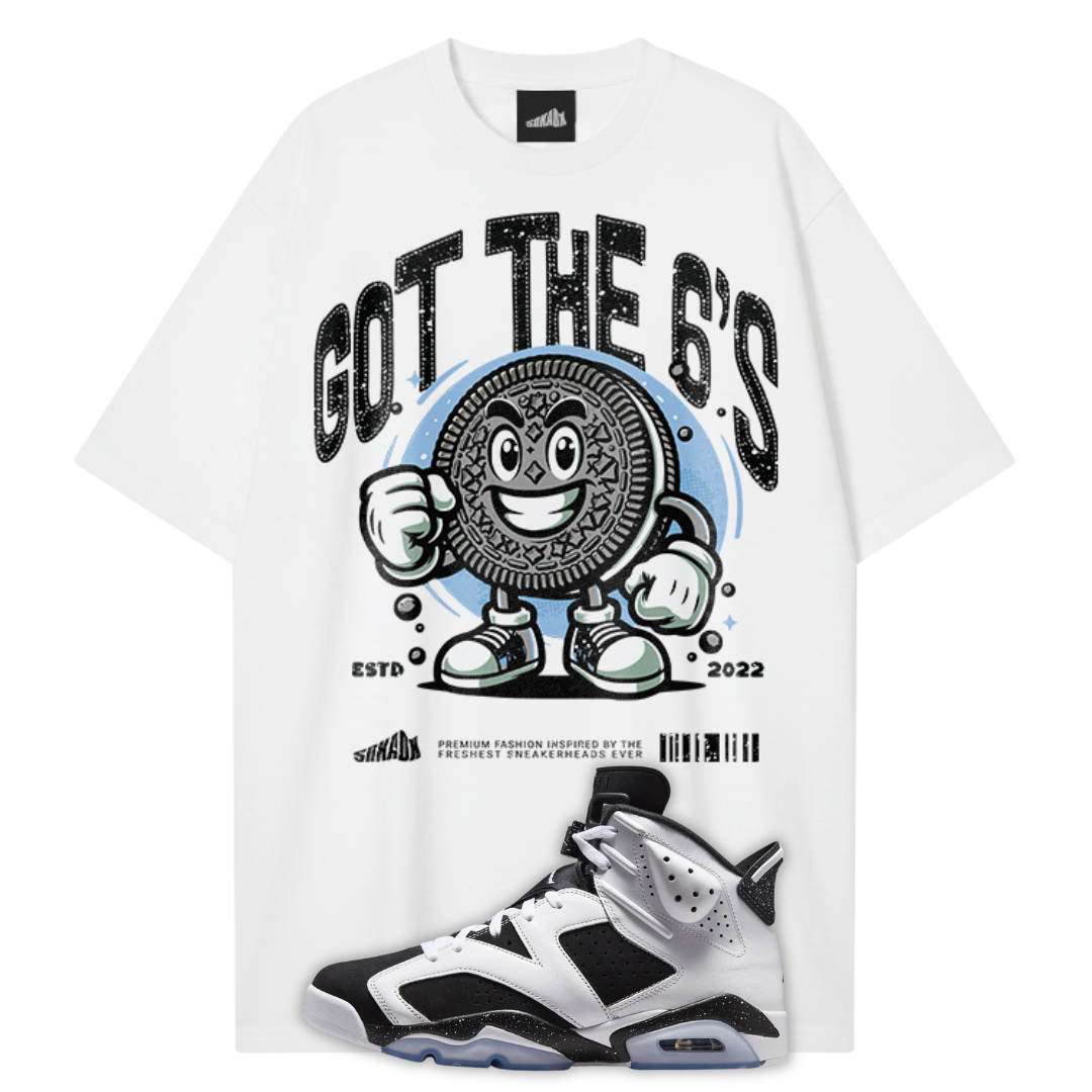 A white graphic T-shirt featuring a large black and blue Oreo-themed print with the text 'GOT THE 6'S' and 'ESTD 2022'. A white, black, and silver Air Jordan 6 Orio sneaker is superimposed at the bottom right.