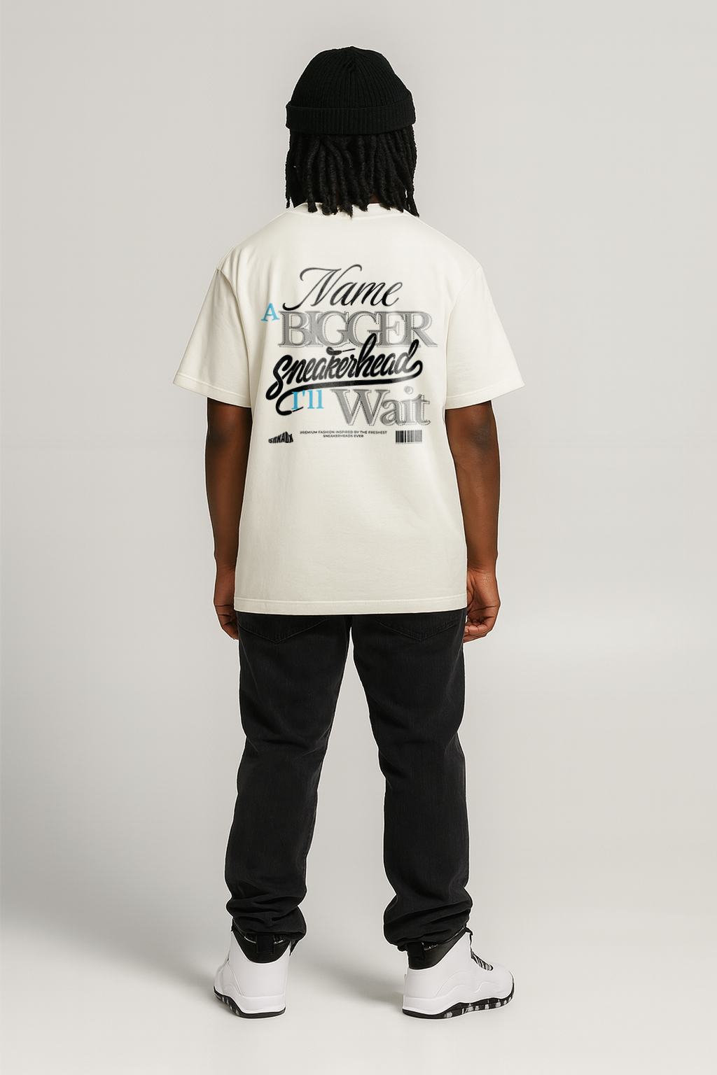 Person wearing a white t-shirt with text on the back against a plain background