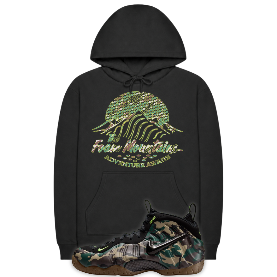Back hoodie with image of mountains in a camouflage print and a Nike Air Foamposite Pro Camo sneakers in the front