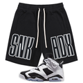 Black athletic shorts with white drawstrings and large white outlined 'SNK ADX' text on the sides, shown with a black, white, and gray Jordan 6 Oreo sneaker on a plain white background.