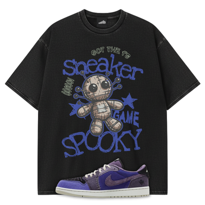 Black t-shirt from SNKADX with graphic design and Zion Williamson x Air Jordan 1 Voodoo Alternate sneakers on a white background.