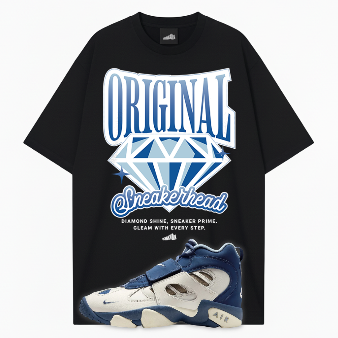 Black t-shirt with 'Original Sneakerhead' graphic and a blue Nike Air Diamond Turf 2 Royals sneaker displayed below on a white background.