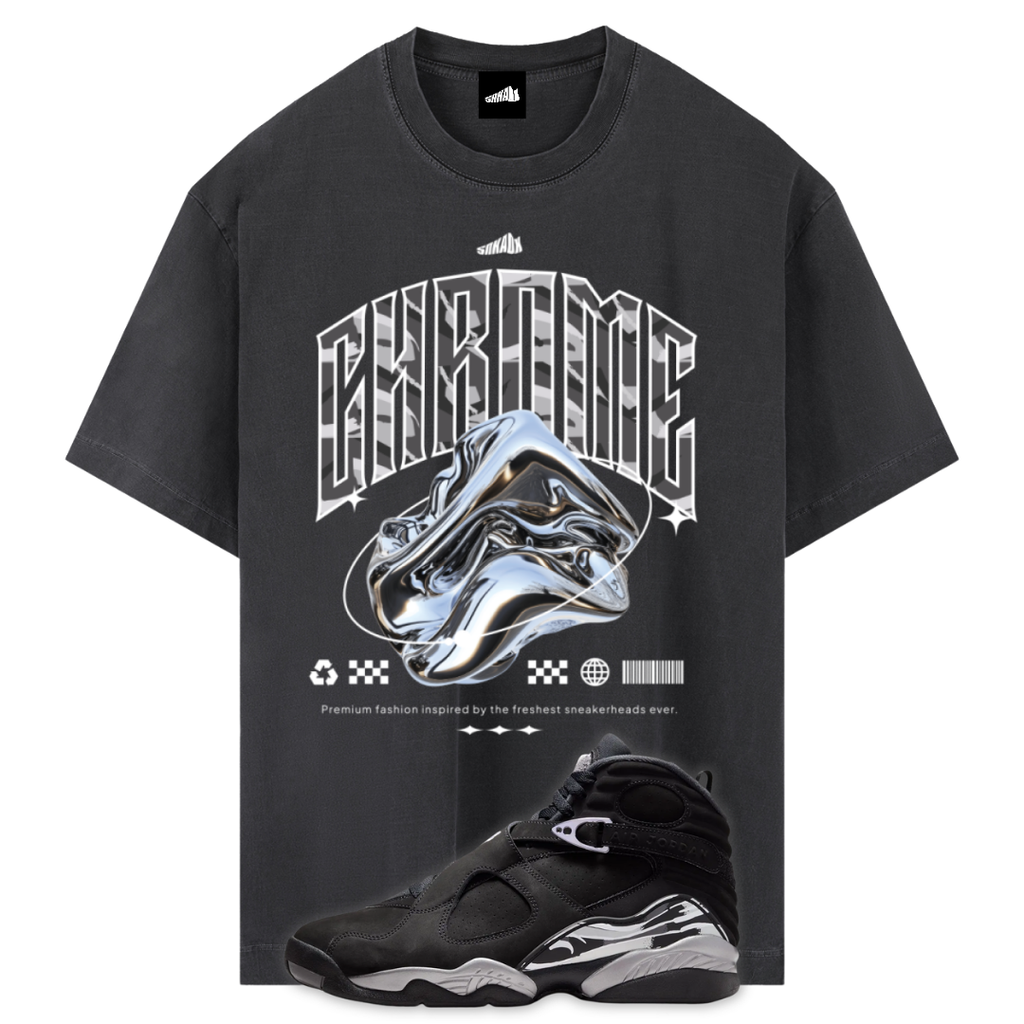 A black graphic t-shirt featuring a large chrome sneaker design and the word 'CHROME' in a metallic font, shown alongside a Air Jordan 8 Chrome sneaker on a white background.