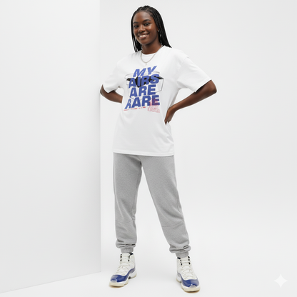 Woman wearing a white t-shirt with text matching Air Jordan 11 Rare Air and gray sweatpants on a white background
