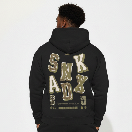 MAN wearing a black hoodie and pants with 'SNKADX' branding on a white background