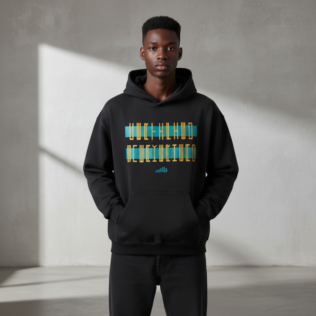 Man wearing a black hoodie with colorful text design against a gray background