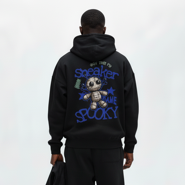 Man wearing a black hoodie with text and graphics on the back, standing against a white background