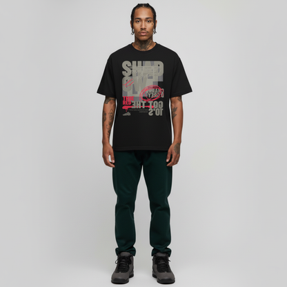 Man wearing a black t-shirt with graphic design on a plain background