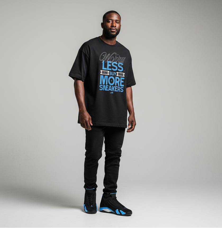 Man wearing a black t-shirt with text and black pants and Jordan 14 University Blue on a gray background