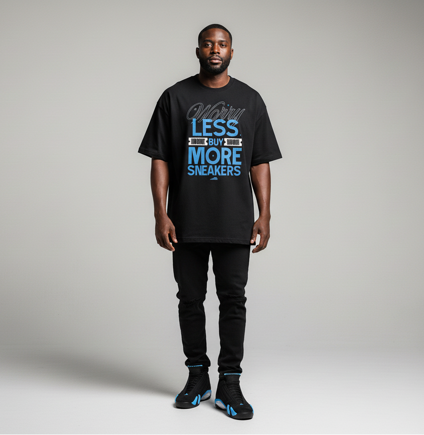 Man wearing a black t-shirt with text and black pants on a gray background