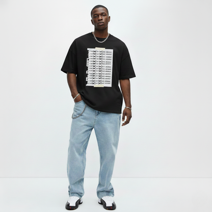 Man wearing a black t-shirt with white graphic design and light blue jeans on a white background with shoes matching air jordan 1 taxi