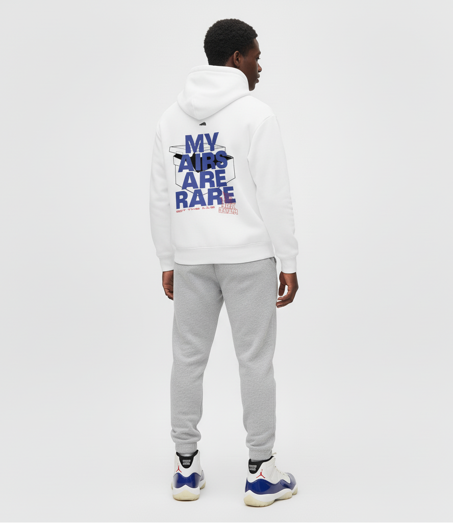 Man wearing a white hoodie with text on the back and gray pants, standing against a white background.