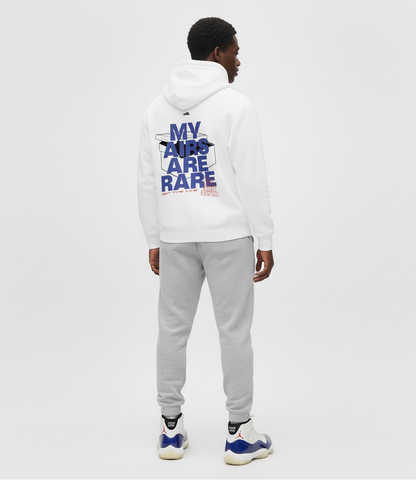 Man wearing a white hoodie with text on the back and gray pants, standing against a white background.