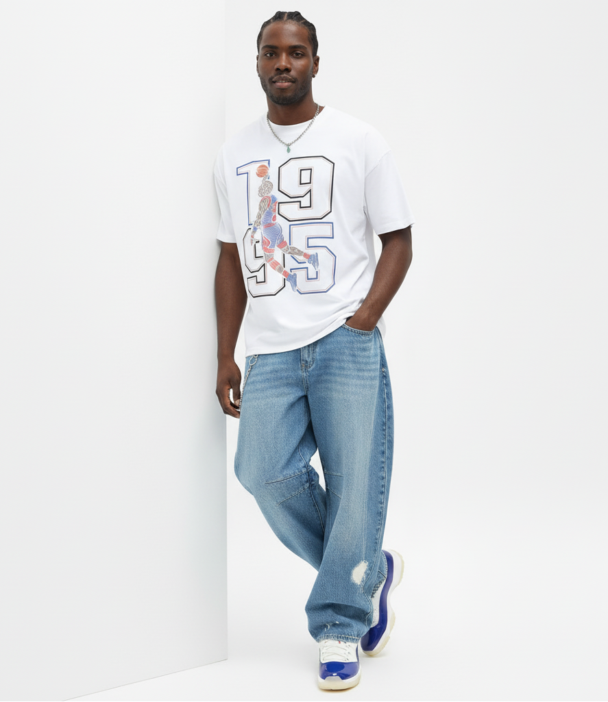 Man wearing a white t-shirt with a graphic design and blue jeans on a white background