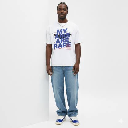 Man wearing a white t-shirt with text and blue jeans on a white background