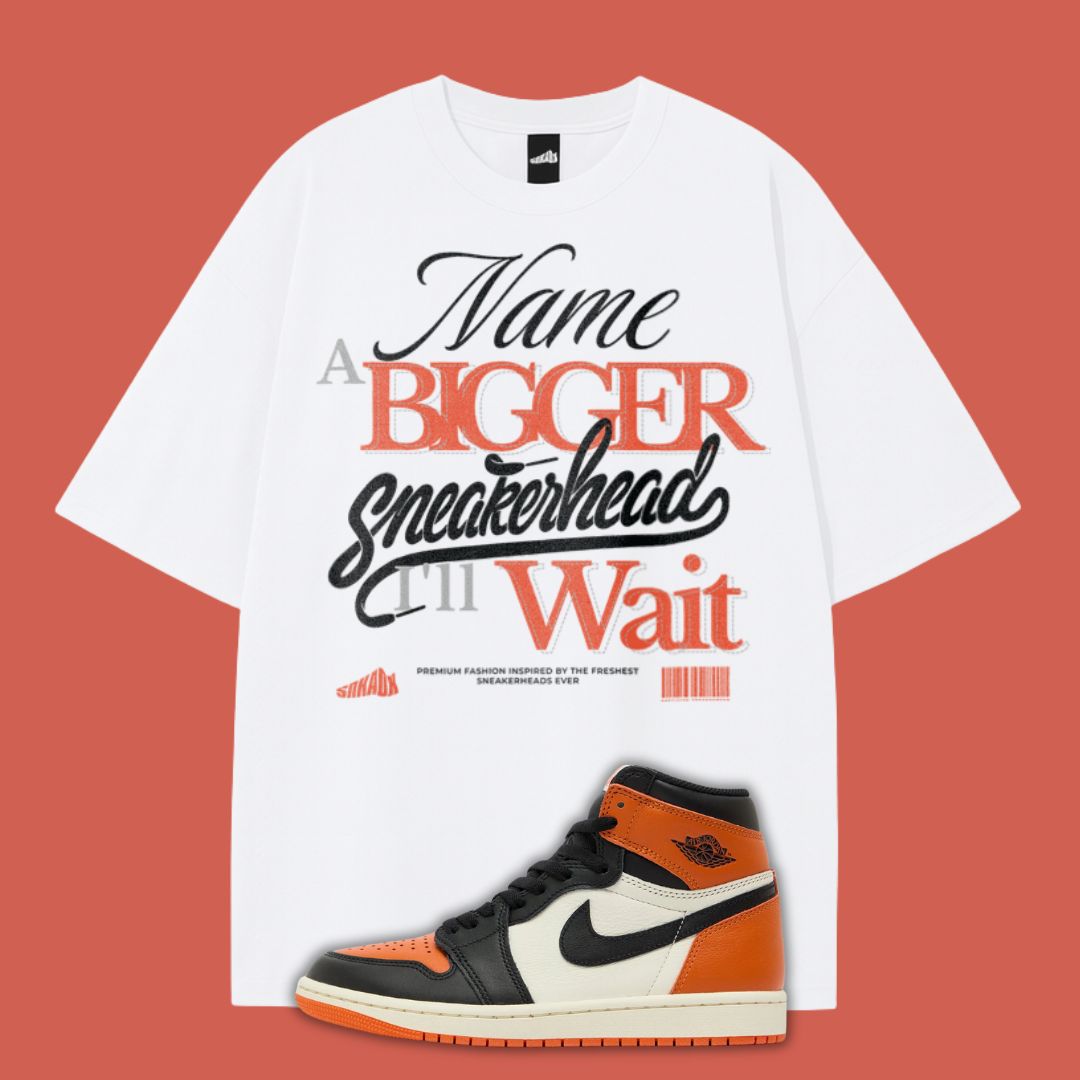 White typography t-shirt with text and an Air Jordan 1 Shattered Backboard sneaker on a red background