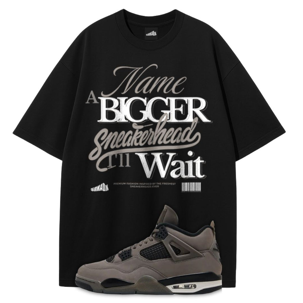 Black t-shirt with white text and a gray Air Jordan 4 Cave Stone on a white background