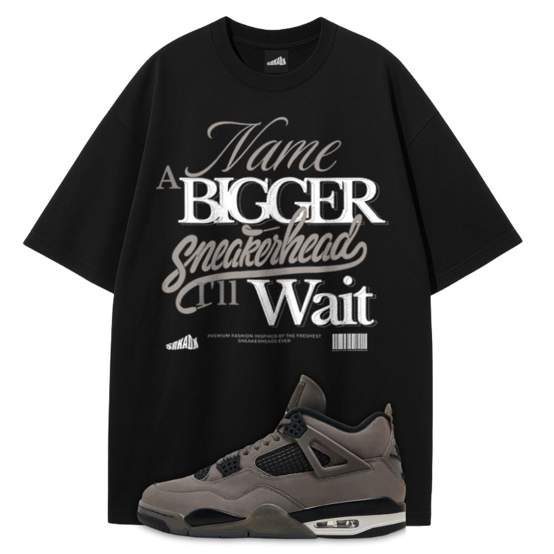 Black t-shirt with white text and a gray Air Jordan 4 Cave Stone on a white background