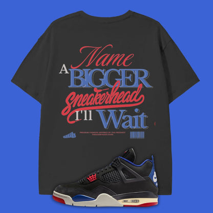 Black t-shirt with colorful text and a black sneaker with red and blue accents on a blue background