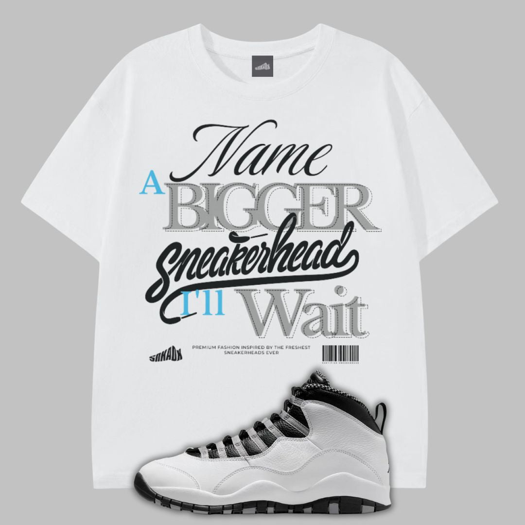 White t-shirt with graphic text and a white sneaker on a gray background