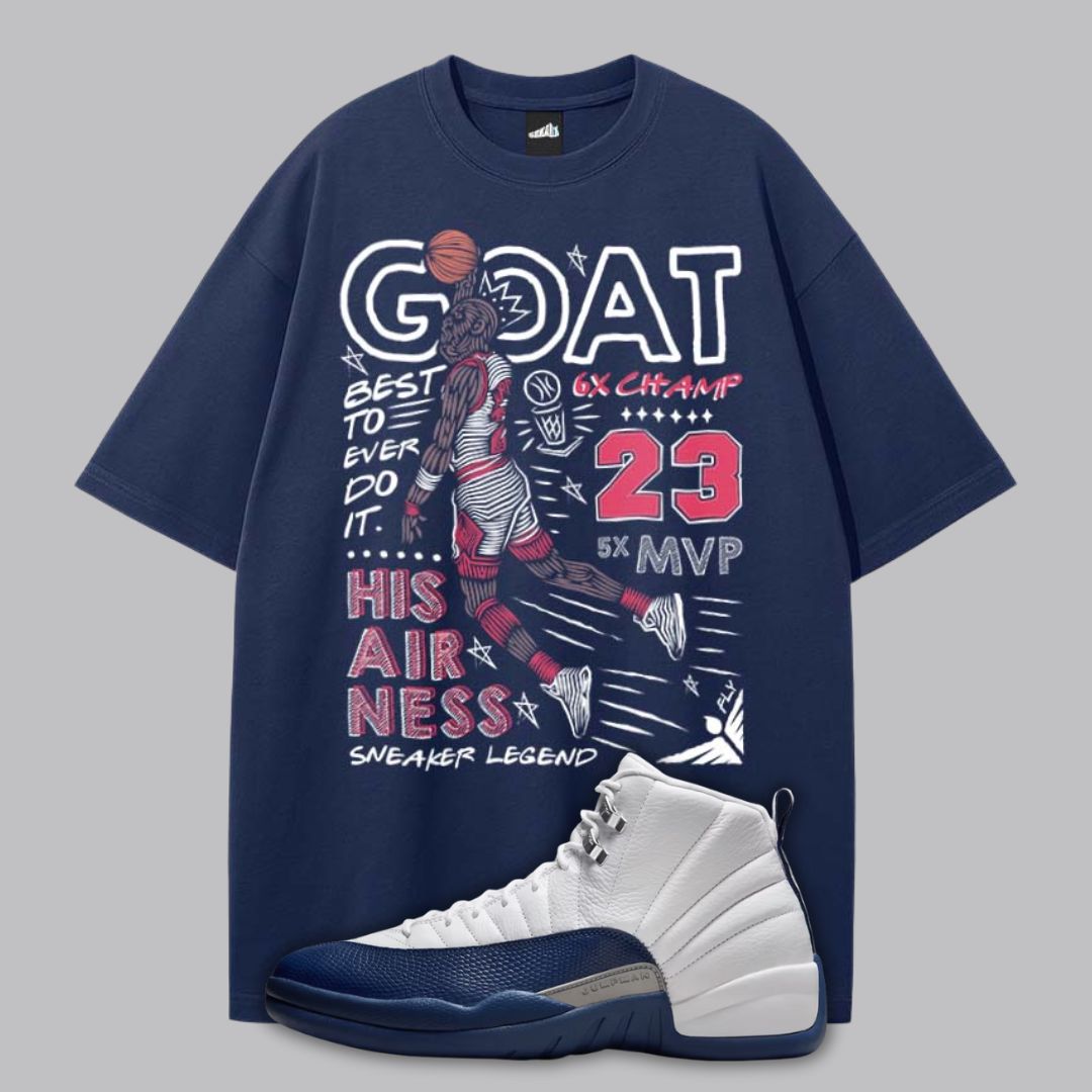 Navy blue t-shirt with Michael Jordan dunking graphic and Air Jordan 12 French Blue sneakers on a gray background.