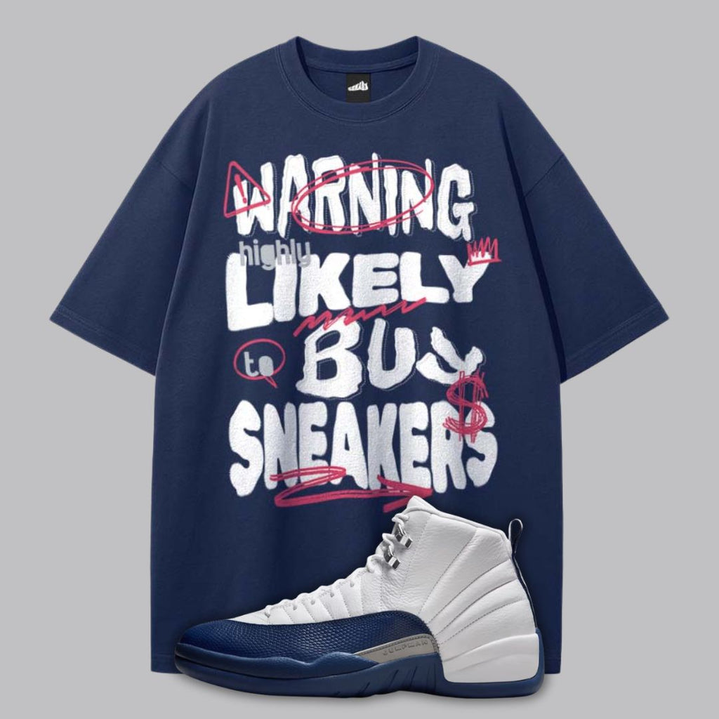 Navy blue t-shirt with humorous text design and a Air Jordan 12 French Blue sneaker on a gray background