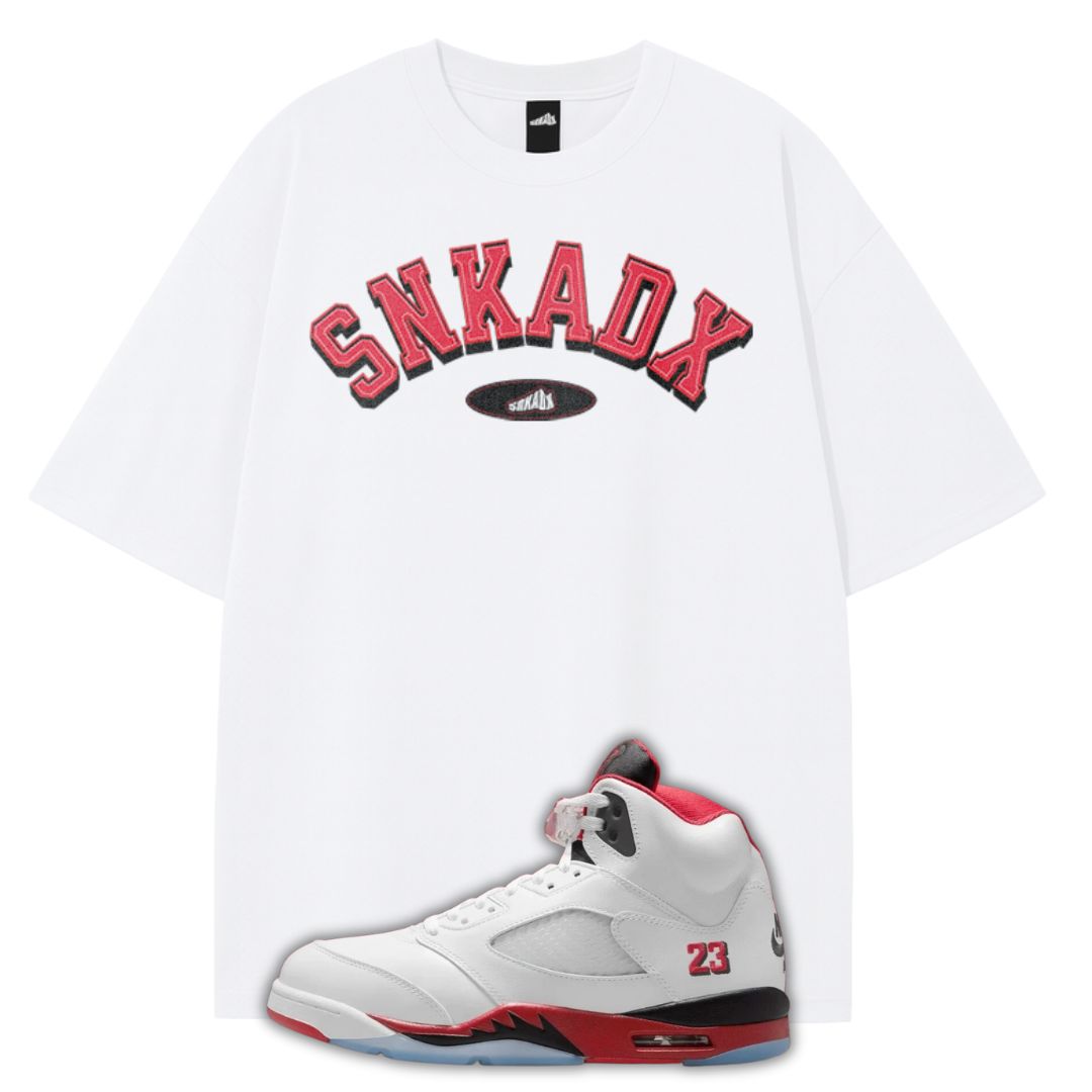 White t-shirt with red and black text and a white Air Jordan 5 Fire Red sneaker with red accents on a white background