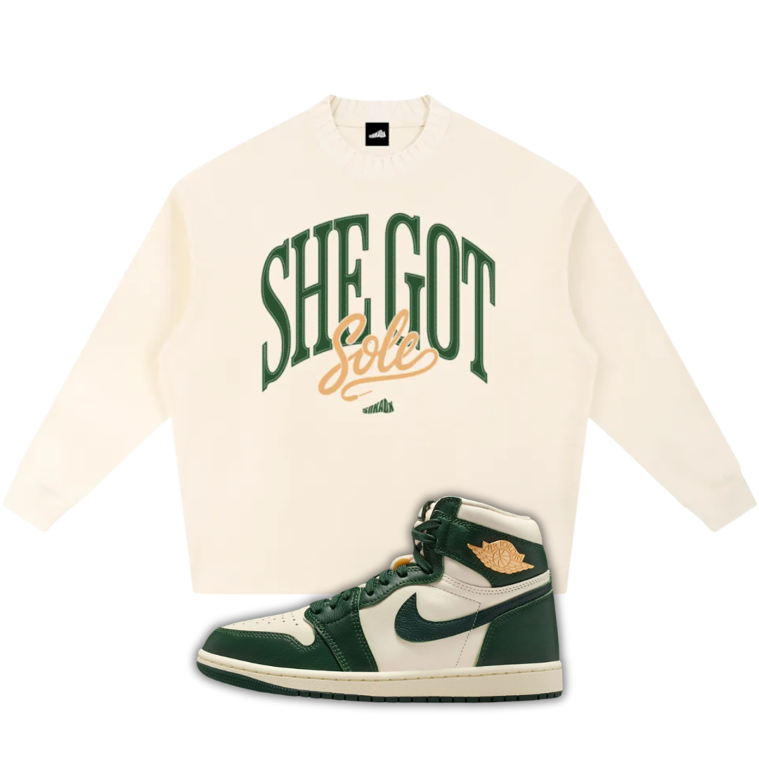 Beige sweatshirt with 'SHE GOT SOLE' text and a Air Jordan 1 High OG Fir Pro Green sneaker on a white background