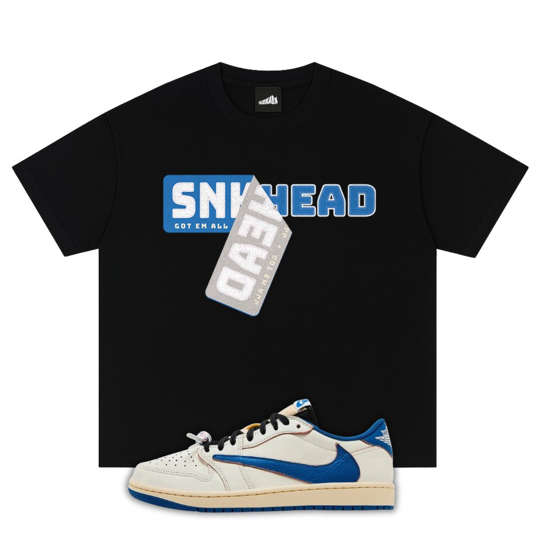 Black t-shirt with 'SNKHEAD' graphic and a white fragment x Travis Scott x Air Jordan 1 Low White/Blue sneaker with blue accents on a white background