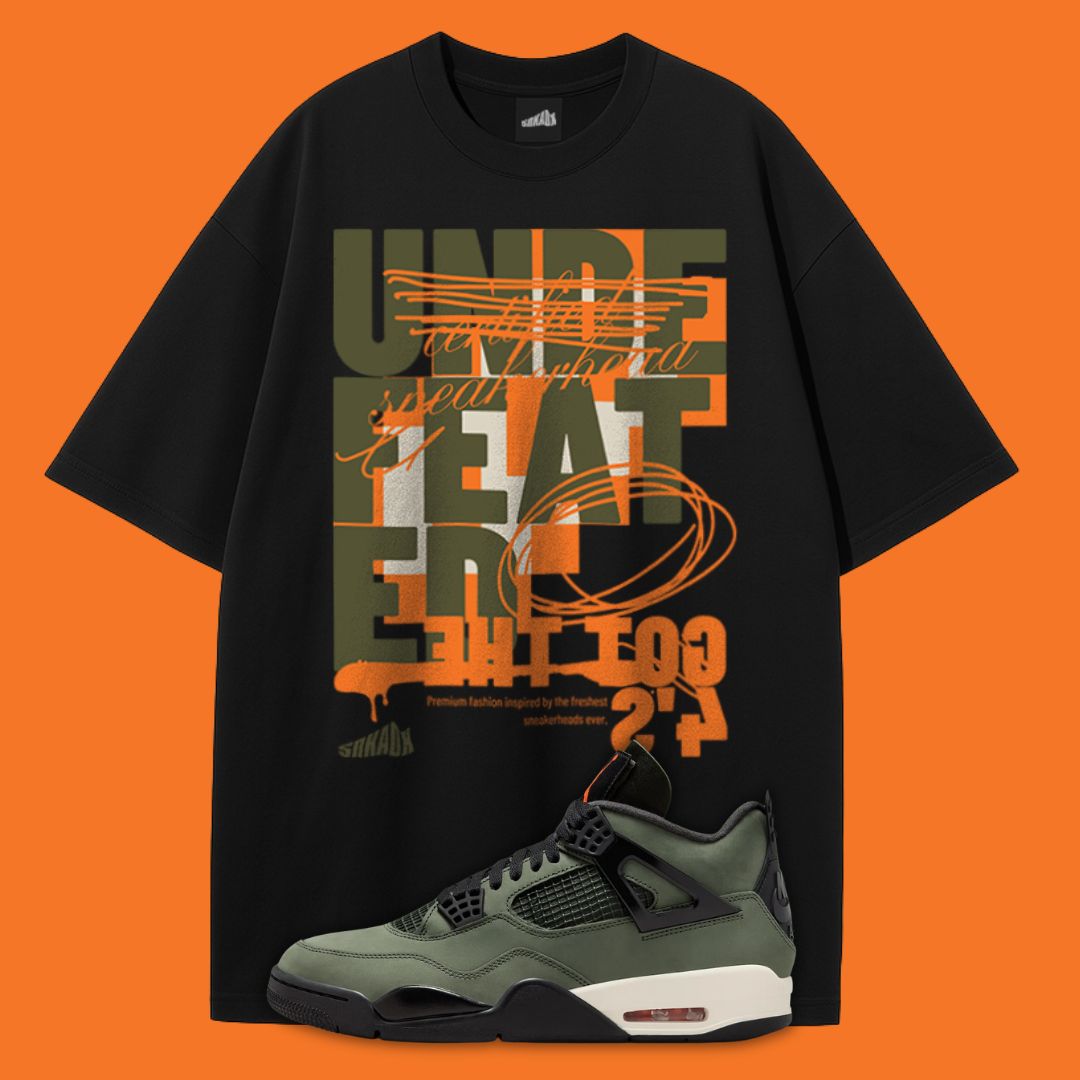 Black t-shirt with orange and green graphic design on an orange background, featuring an Air Jordan 4 Undefeated sneaker.