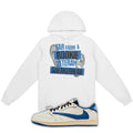 White hoodie with Far From A Rookie Veteran Sneakerhead on the front and a blue and white fragment x Travis Scott x Air Jordan 1 Low White/Blue on a white background