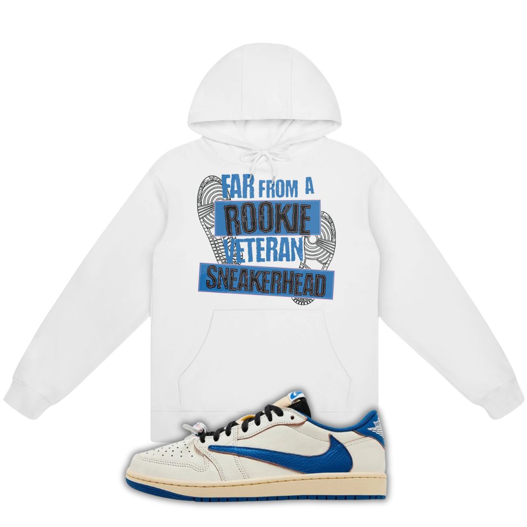 White hoodie with Far From A Rookie Veteran Sneakerhead on the front and a blue and white fragment x Travis Scott x Air Jordan 1 Low White/Blue on a white background