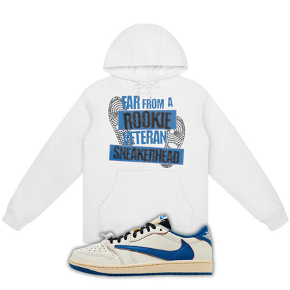 White hoodie with Far From A Rookie Veteran Sneakerhead on the front and a blue and white fragment x Travis Scott x Air Jordan 1 Low White/Blue on a white background