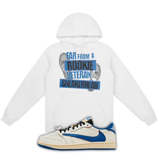 White hoodie with Far From A Rookie Veteran Sneakerhead on the front and a blue and white fragment x Travis Scott x Air Jordan 1 Low White/Blue on a white background