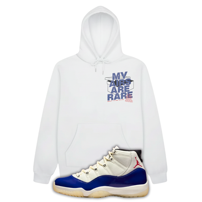 White hoodie with 'MY AIRS ARE RARE' text and a Air Jordan 11 Rare Air sneaker with blue accents on a white background