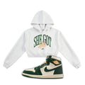 White hoodie with 'SHE GOT SOLE' text and a green and white Air Jordan 1 on a white background
