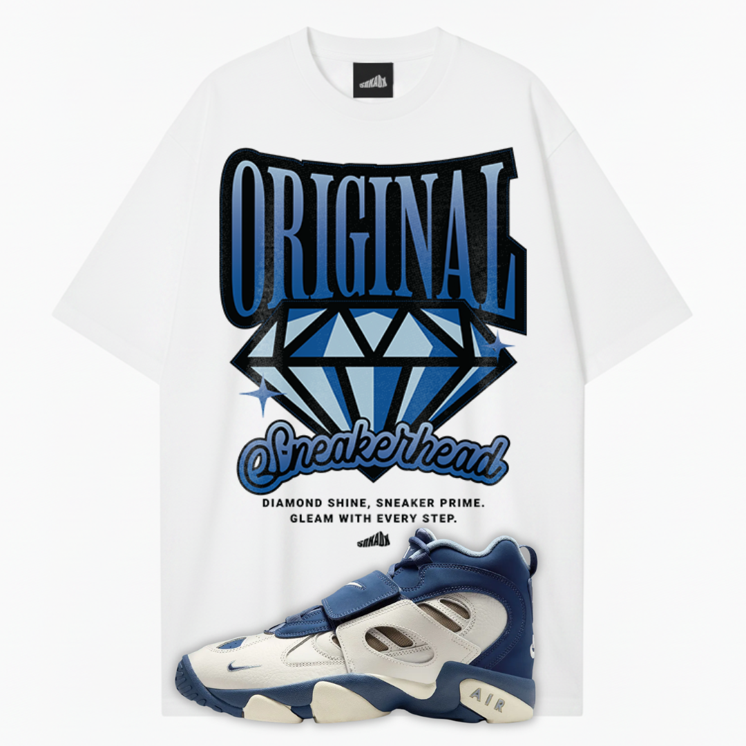 White t-shirt with 'Original Sneakerhead' graphic and blue Nike Air Diamond Turf 2 Royals sneakers on a white background