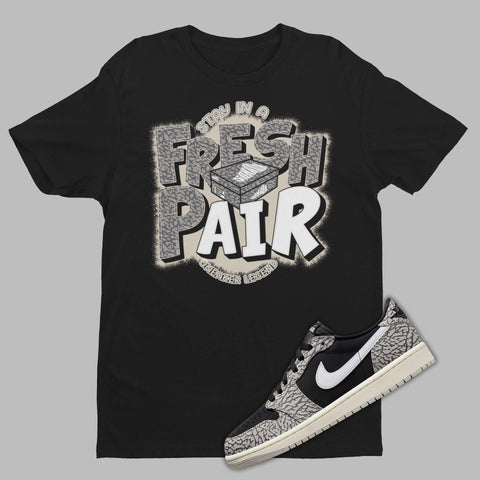 Fresh Pair Shirt Matching Air Jordan 1 Low Black Cement with shoe box on the front.
