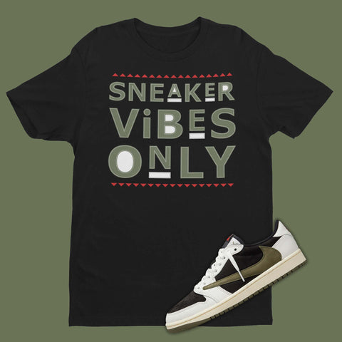 A black cotton crewneck t-shirt with short sleeves, featuring a simple yet stylish design that complements the bold green, white and black colorway of the Travis Scott Jordan 1 Low Olive sneakers. The t-shirt has a comfortable and relaxed fit, perfect for casual outings or everyday wear